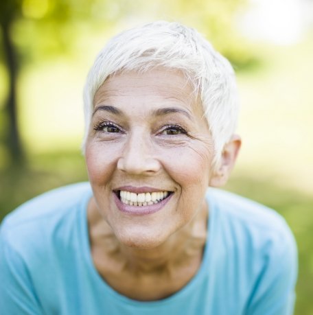 Woman with implant dentures smiling
