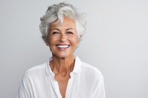 Senior woman in white shirt smiling