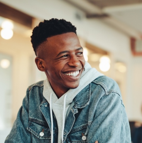 Young man with flawless smile after clear correct orthodontics