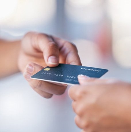 Person handing their credit card to someone else