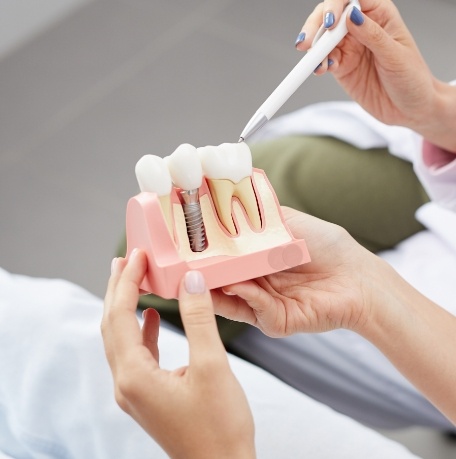 Dentist explaining dental implants to dentistry patient