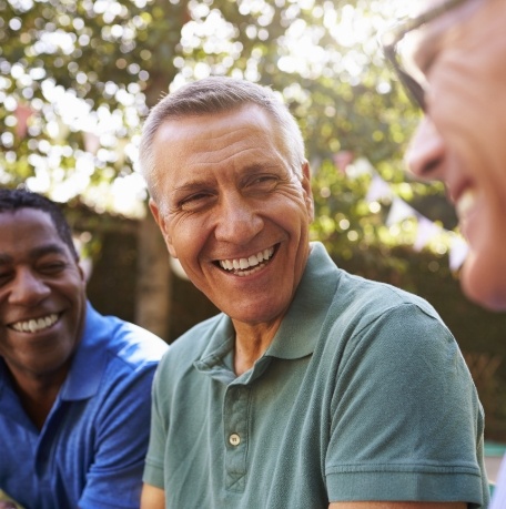 Man smiling after dental implant tooth replacement