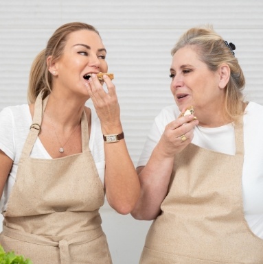 Two women eating a snack together