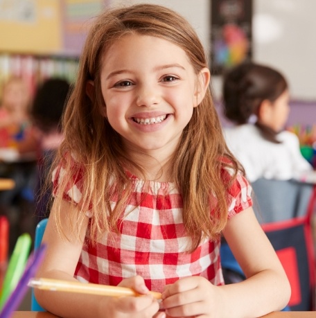 Child with dental sealants smiling