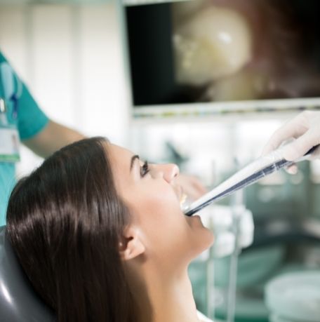 Dentist using intraoral camera to capture smile images