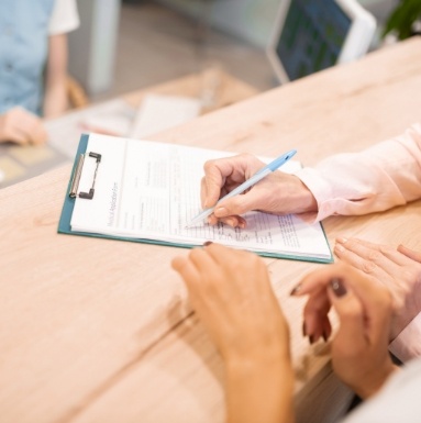 Dentistry patient filling out dental insurance forms