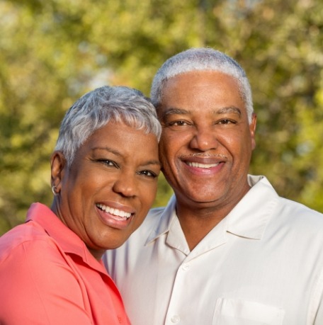 Man and woman with dentures smiling