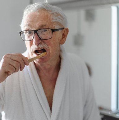 Dentures patient in Soldotna brushing their dentures