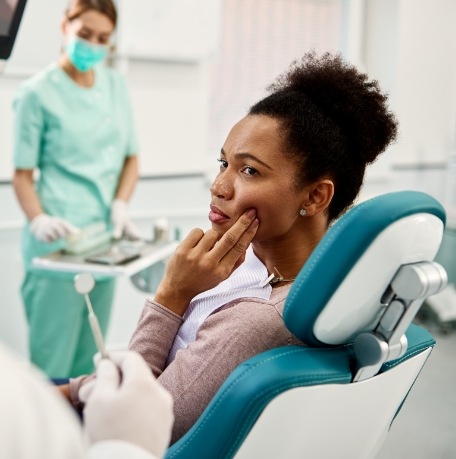 Woman in dental chair for emergency dentistry