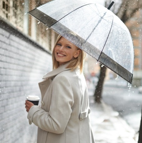 Woman smiling under an umbrella