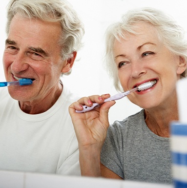 older couple brushing teeth together