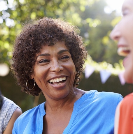 Woman sharing healthy smile after preventive dentistry