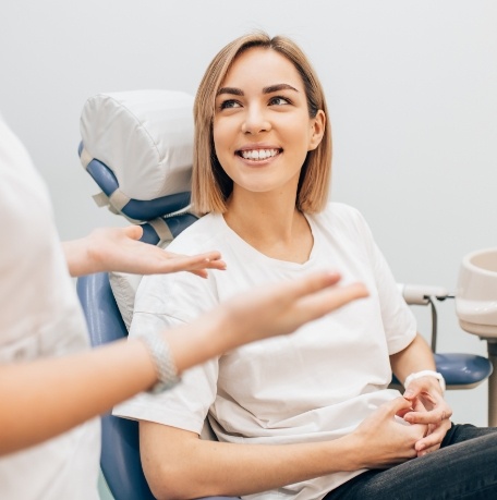 Woman smiling during dental checkup and teeth cleaning visit