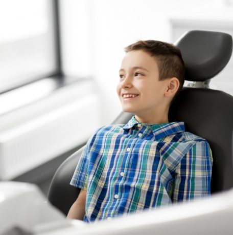 Child smiling during children's dentistry visit