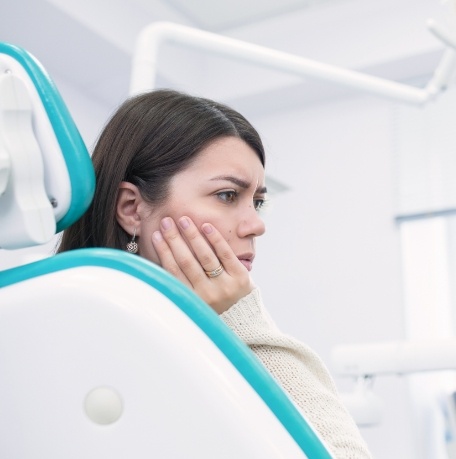 Woman in pain before tooth extraction