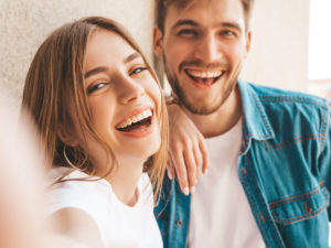Young happy couple smiling after seeing dentist