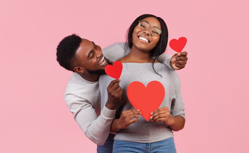 portrait of someone smiling in front of a valentine’s day background