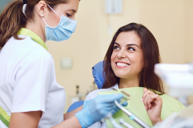 A woman asking her dentist about dental crowns